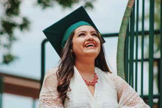 Woman with graduation cap looking at the sky